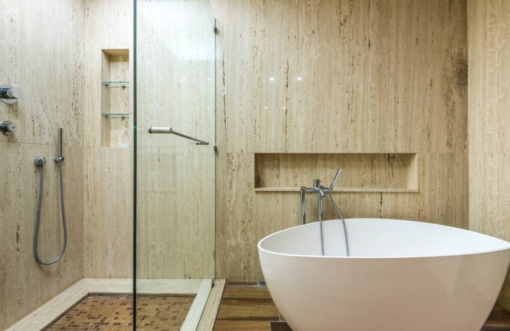 Modern bathroom featuring natural stone finishes, furniture with clean lines, and sleek fixtures.