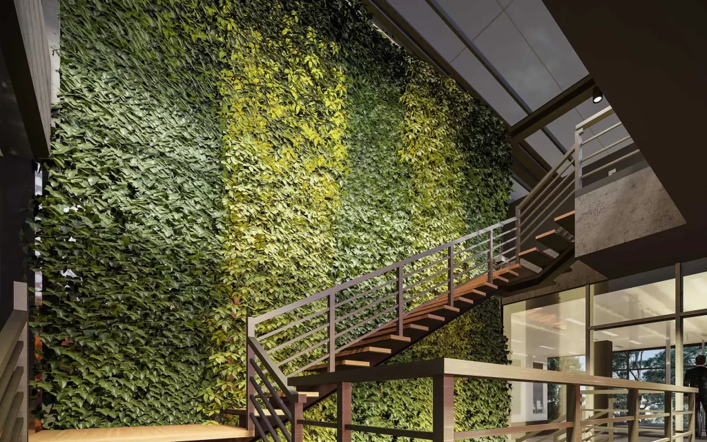 The incorporation of abundant green walls and open air wells creates a naturally ventilated environment, resulting in a refreshing and breezy atmosphere indicative of the hub's innovative and sustainable architectural approach.