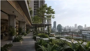 Semi-open residential amenity podium in a Metro Manila condominium development with tropical landscaping and climate-responsive design.