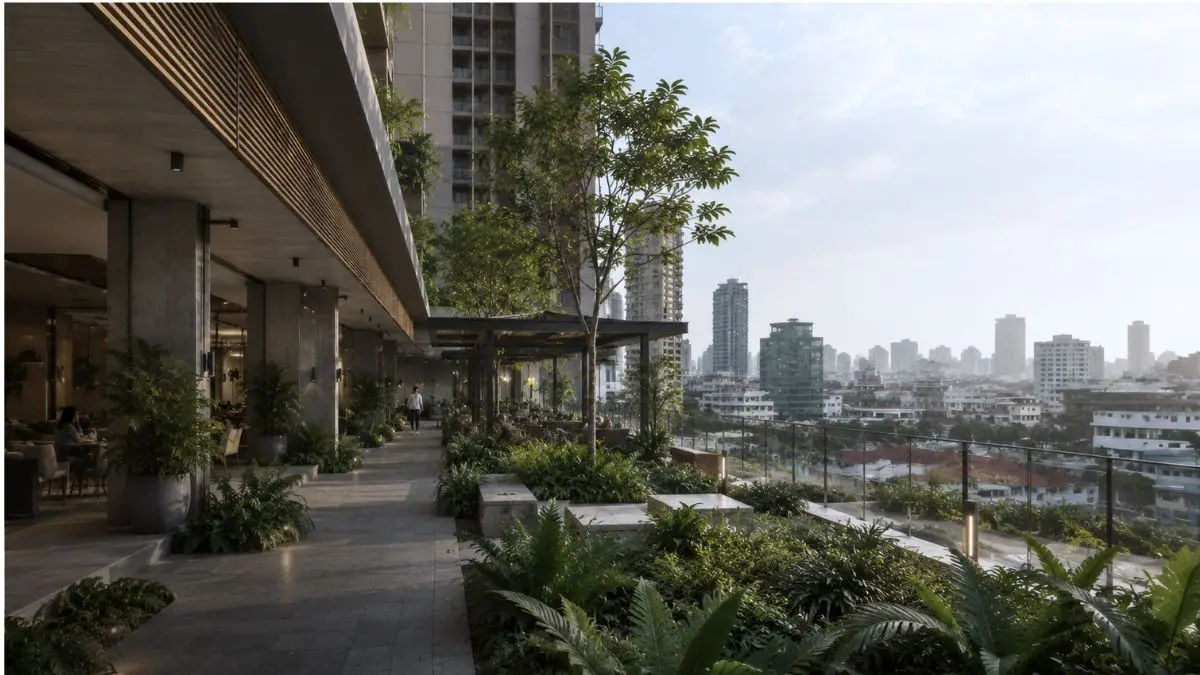 Semi-open residential amenity podium in a Metro Manila condominium development with tropical landscaping and climate-responsive design.