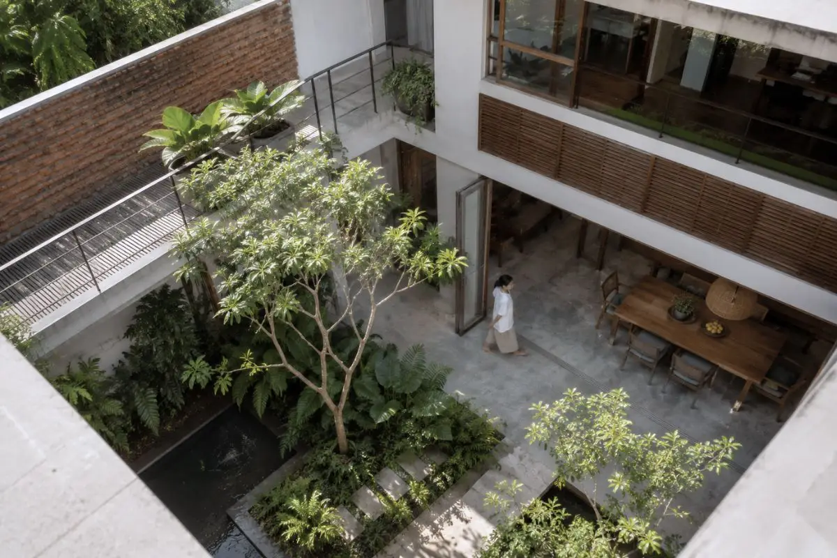 High-angle view of a modern Filipino house with internal courtyard, tropical planting, shaded walkways, and open living areas